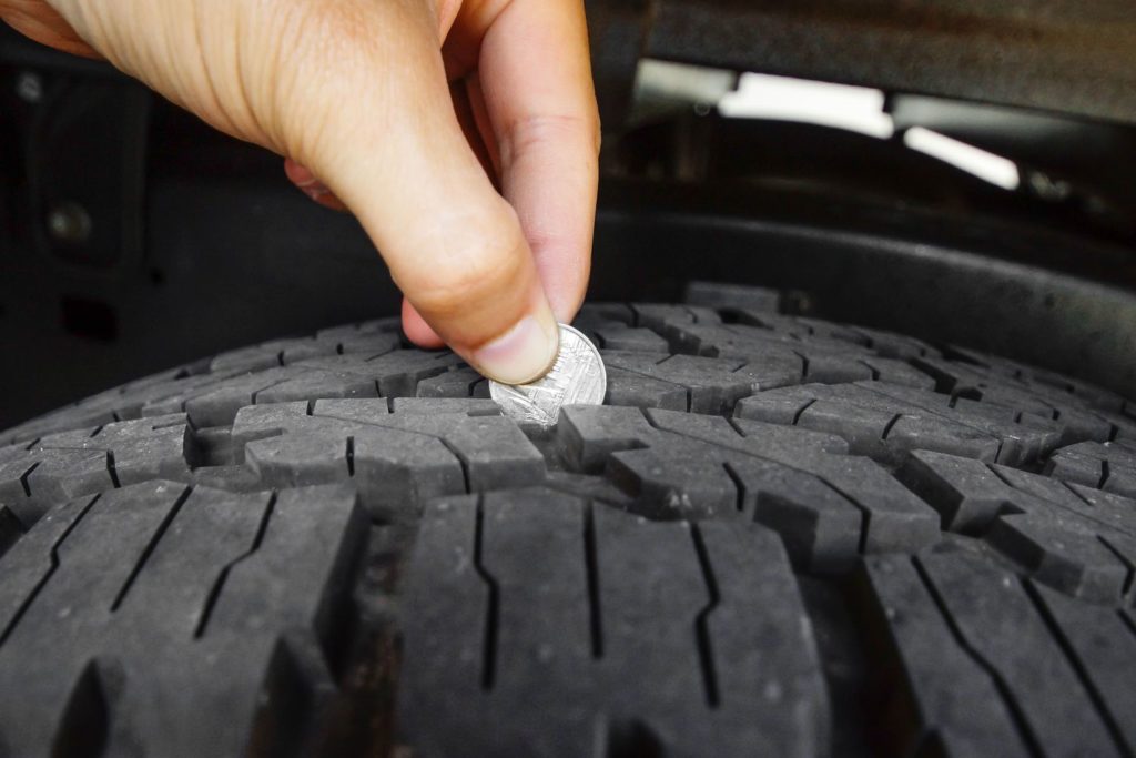 measuring tire depth to avoid accidents.